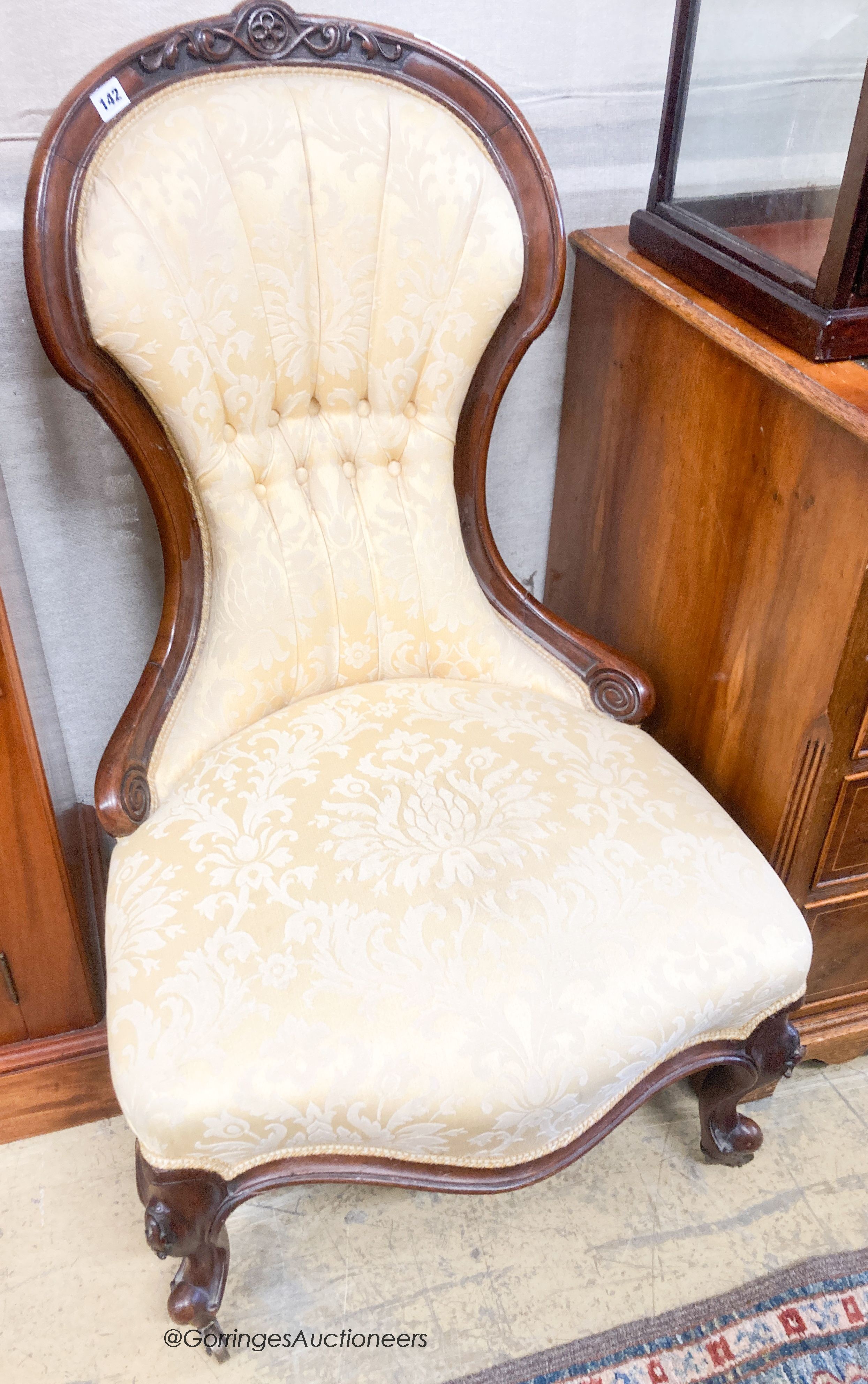 A Victorian walnut spoonback nursing chair